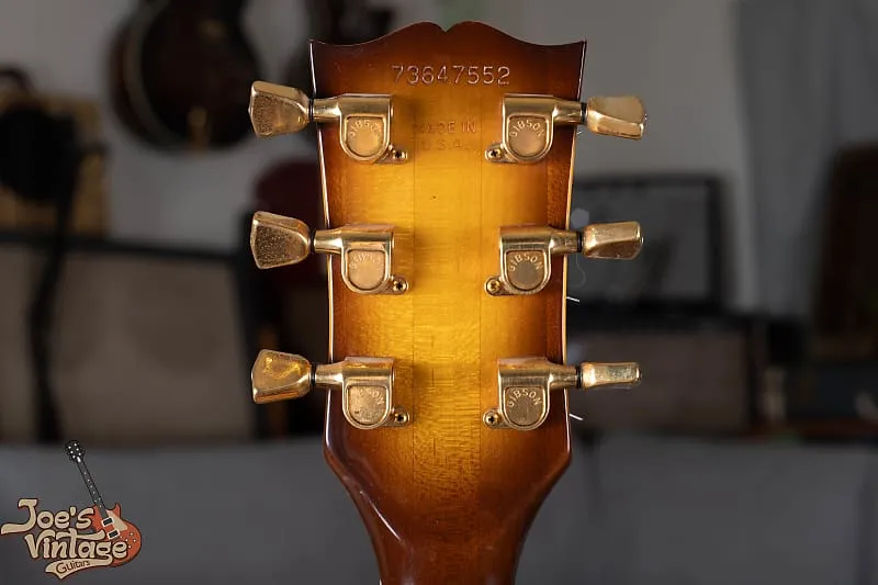 Back of the headstock on a 1977 Les Paul Custom showing serial stamp and gold tuners