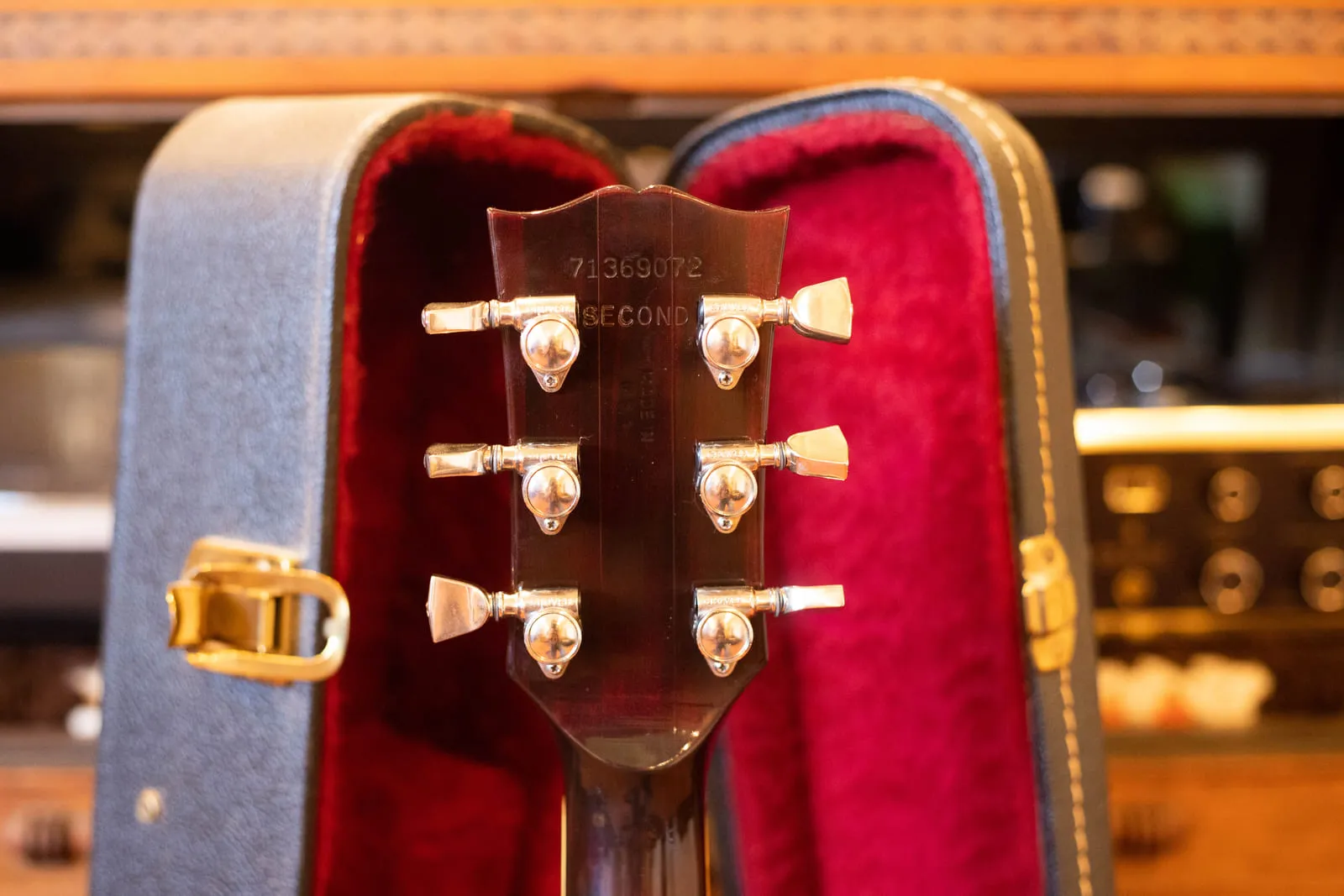 Back of the headstock of a 1979 Gibson Hummingbird showing the impressed serial number 71369072 with the word SECOND stamped below it and Grover tuners on either side.
