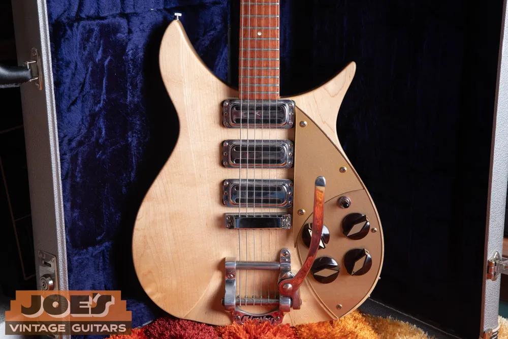 Four broad-topped control knobs on a later Rickenbacker 325 with a gold pickguard