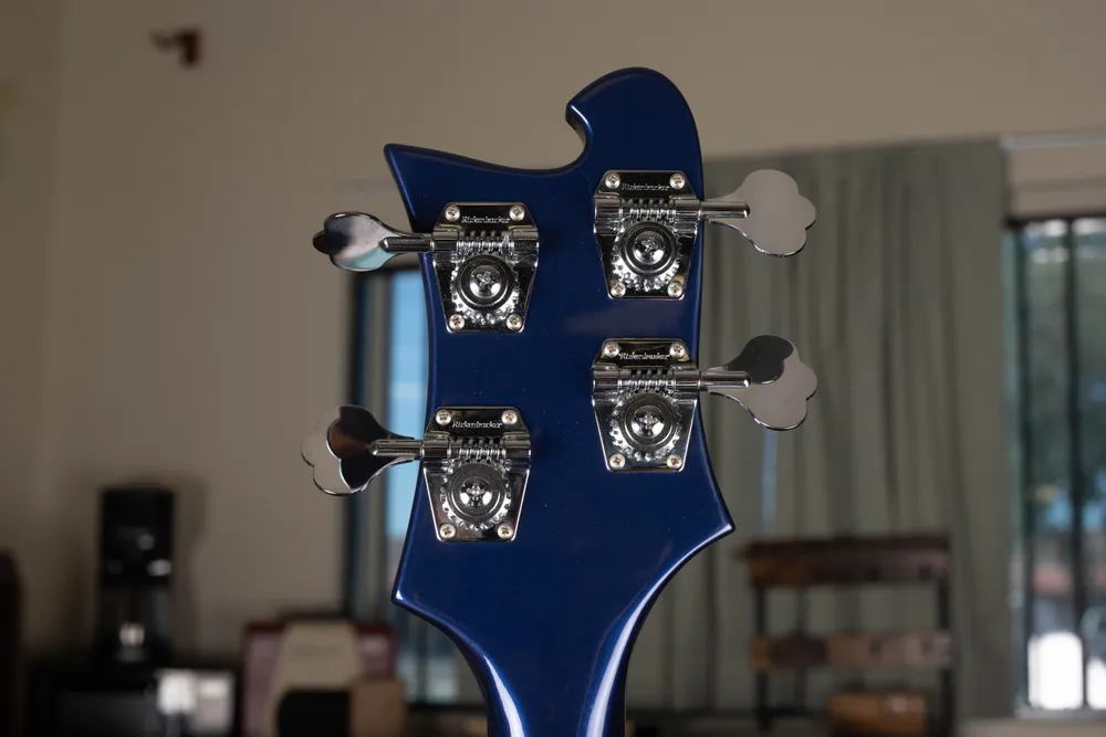 Exposed gears and cloverleaf buttons on Rickenbacker-branded bass tuners