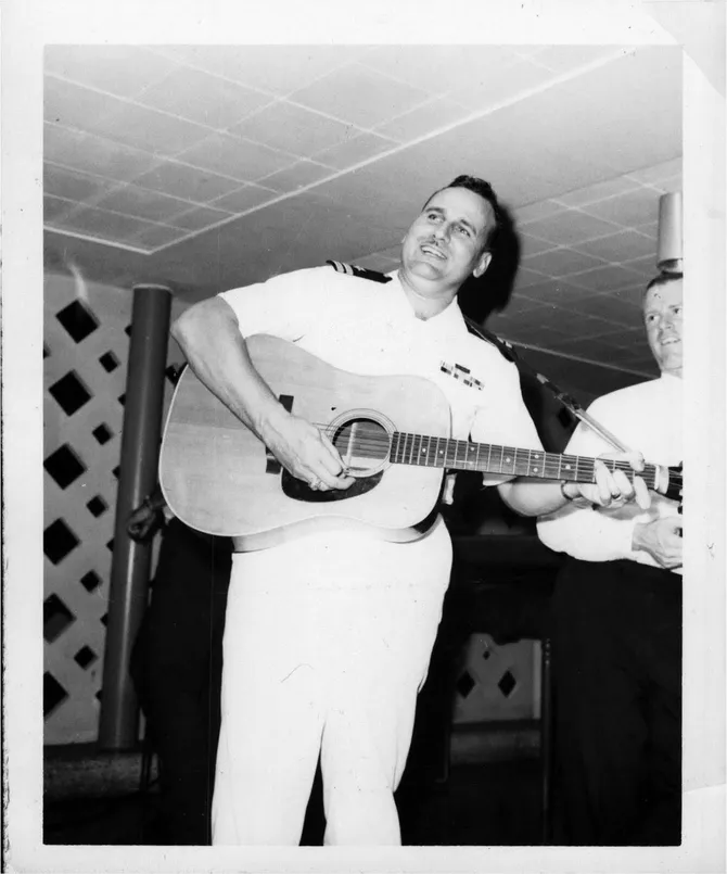Bill Minnich in his Navy uniform playing his Martin D-28