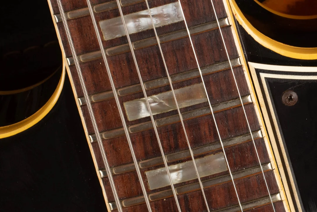 Small rectangular inlays on a Gibson ES-330 rosewood fingerboard