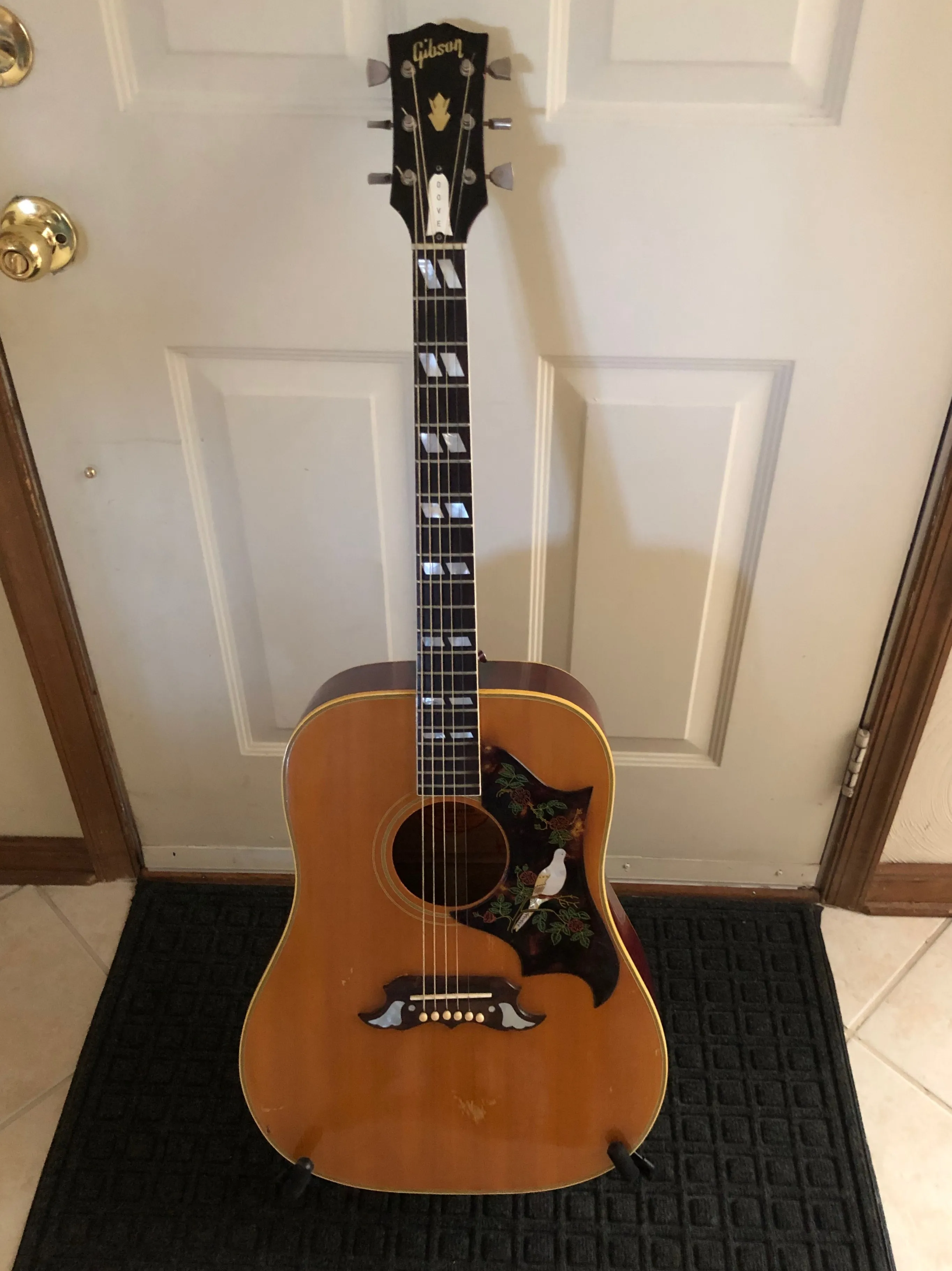 Natural-finish Gibson Dove showing its square shoulders, bird pickguard, decorated bridge and split parallelogram inlays