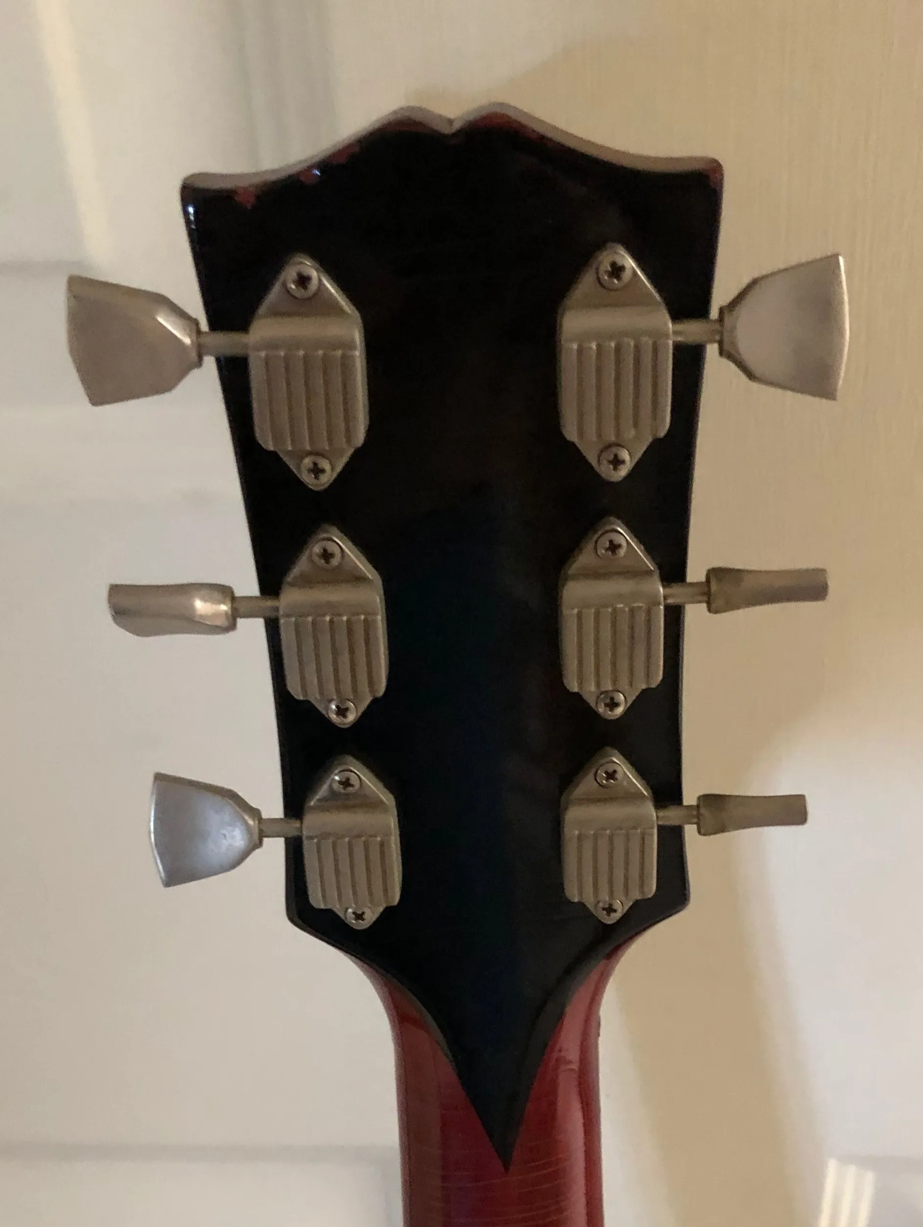 Back of a Gibson Dove headstock with six waffleback tuner housings