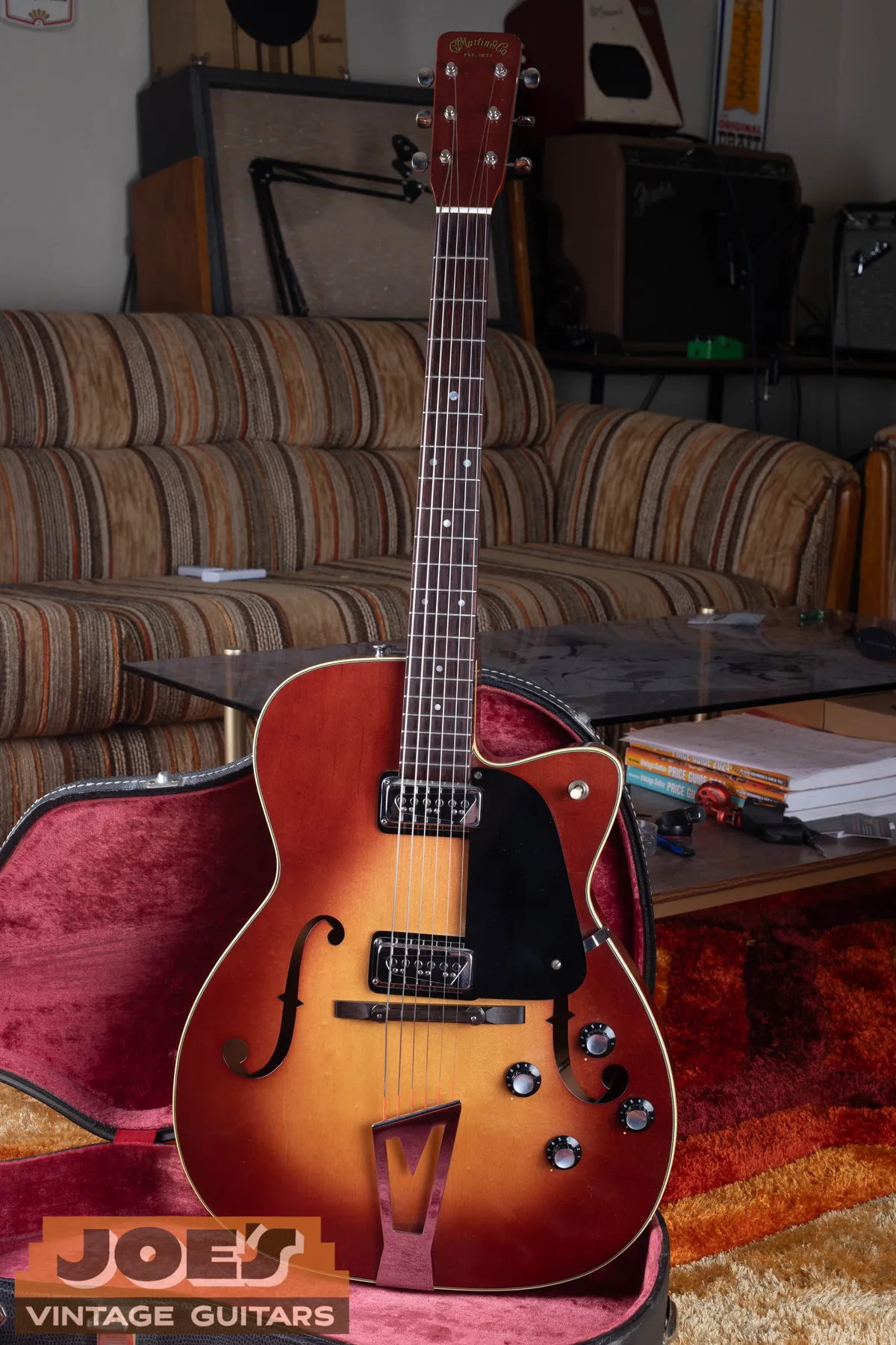 Sunburst single-cutaway Martin F-series electric with two pickups and a V-shaped tailpiece
