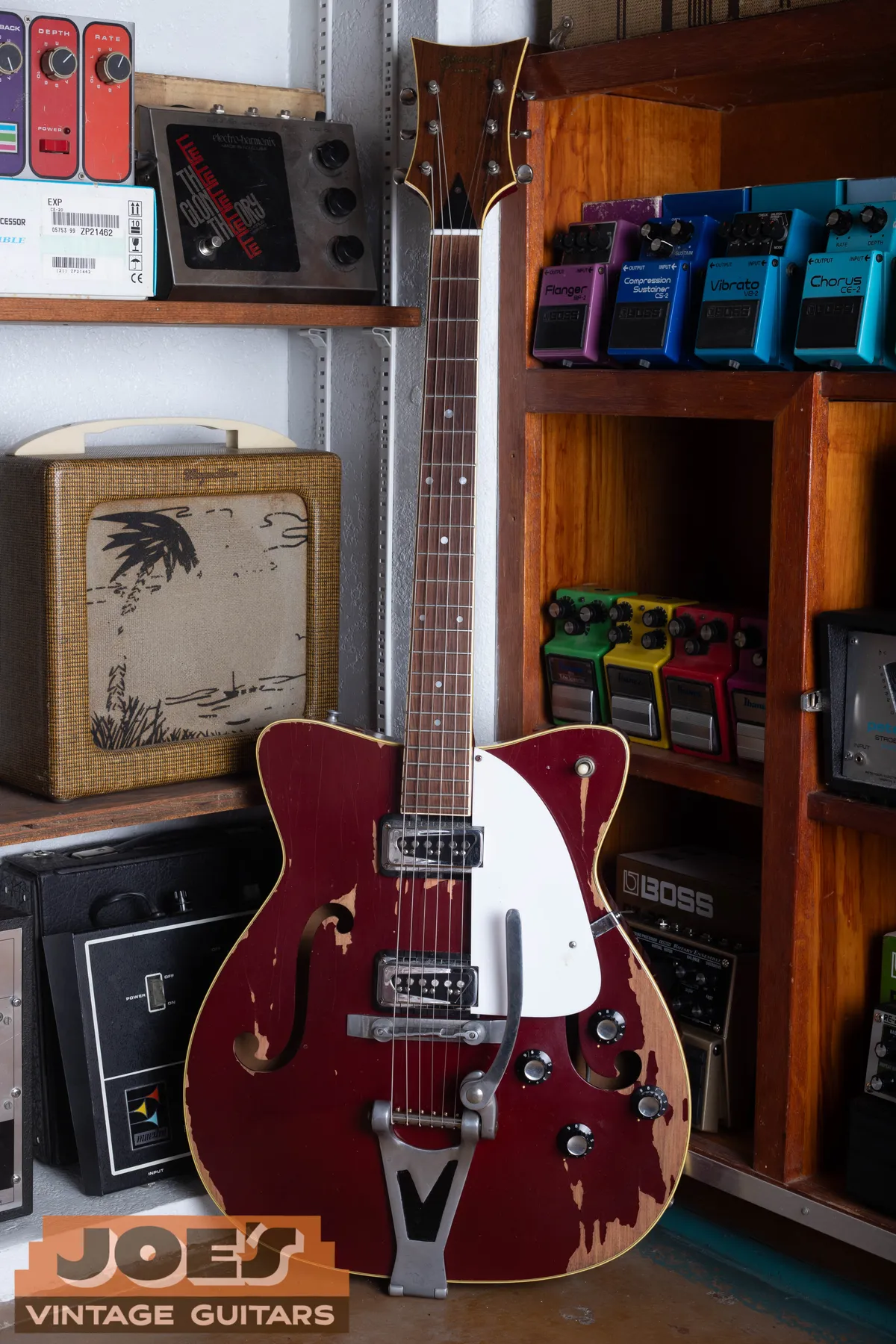 Full front of a cherry Martin GT-75 electric guitar with two pickups and vibrato tailpiece