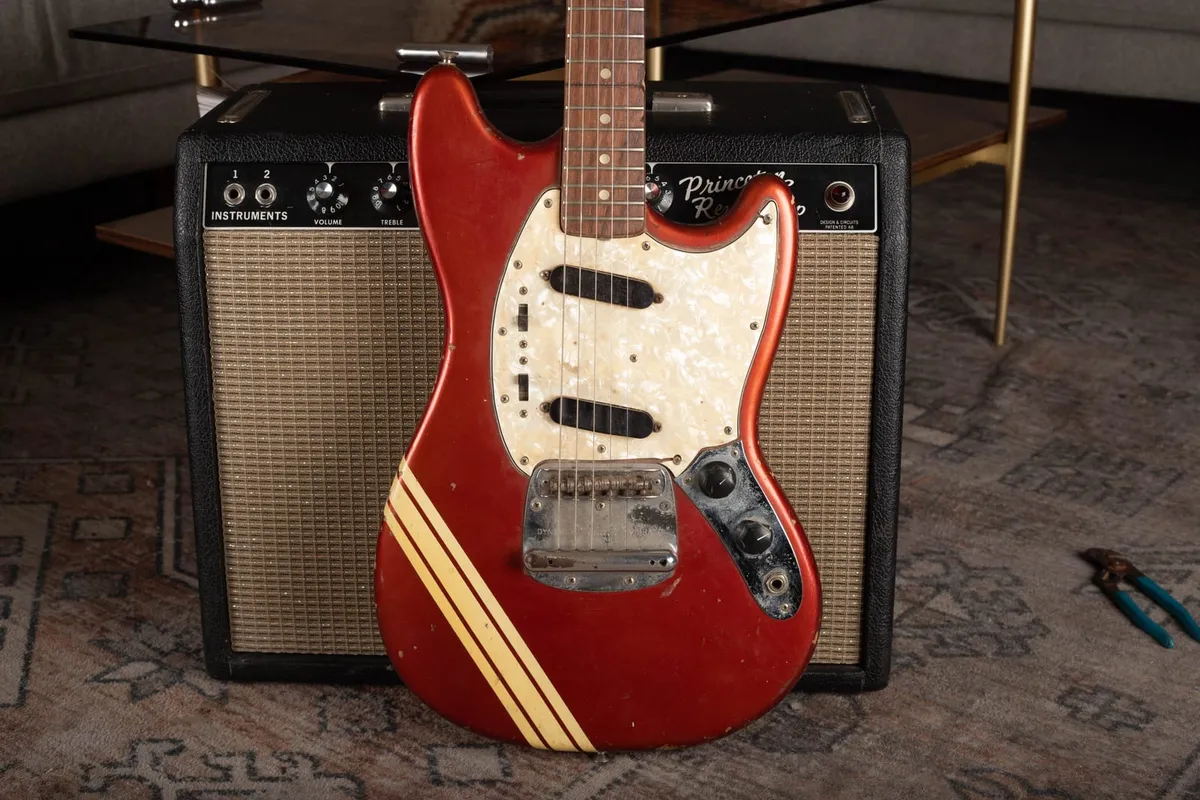 Body of a vintage Fender Competition Mustang in Competition Red showing the diagonal racing stripes across the front