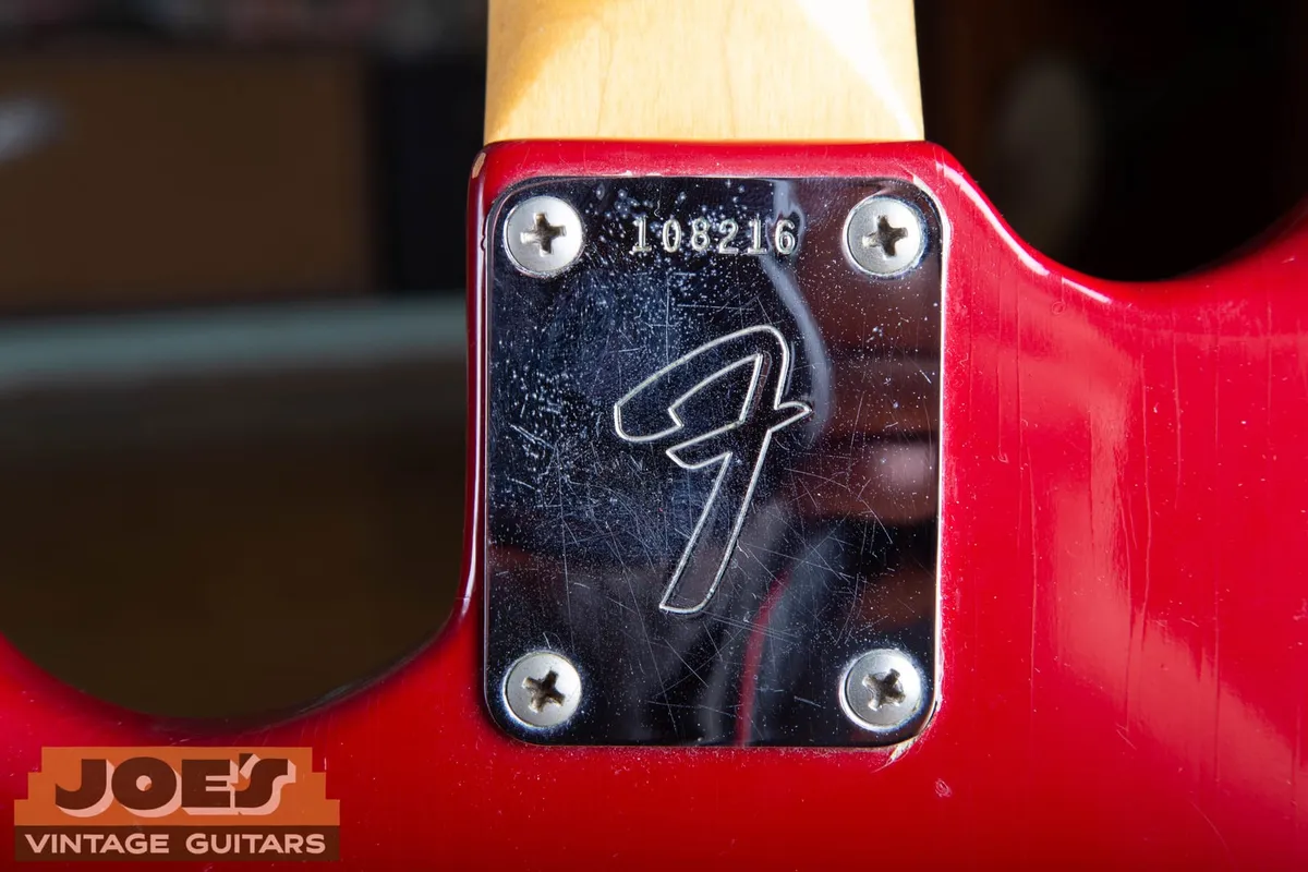 Back of a mid-1960s Fender Mustang neck showing the large F neck plate stamped with serial number 108216