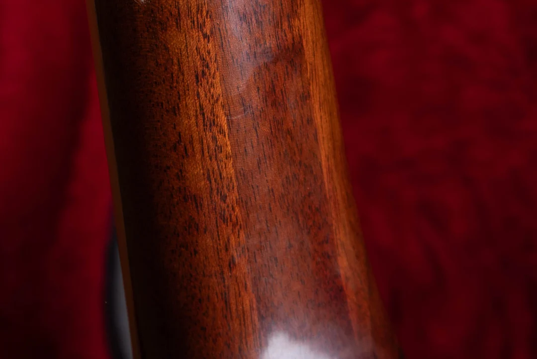 Close view of a three-piece mahogany neck with visible long glue seams on a vintage Gibson guitar