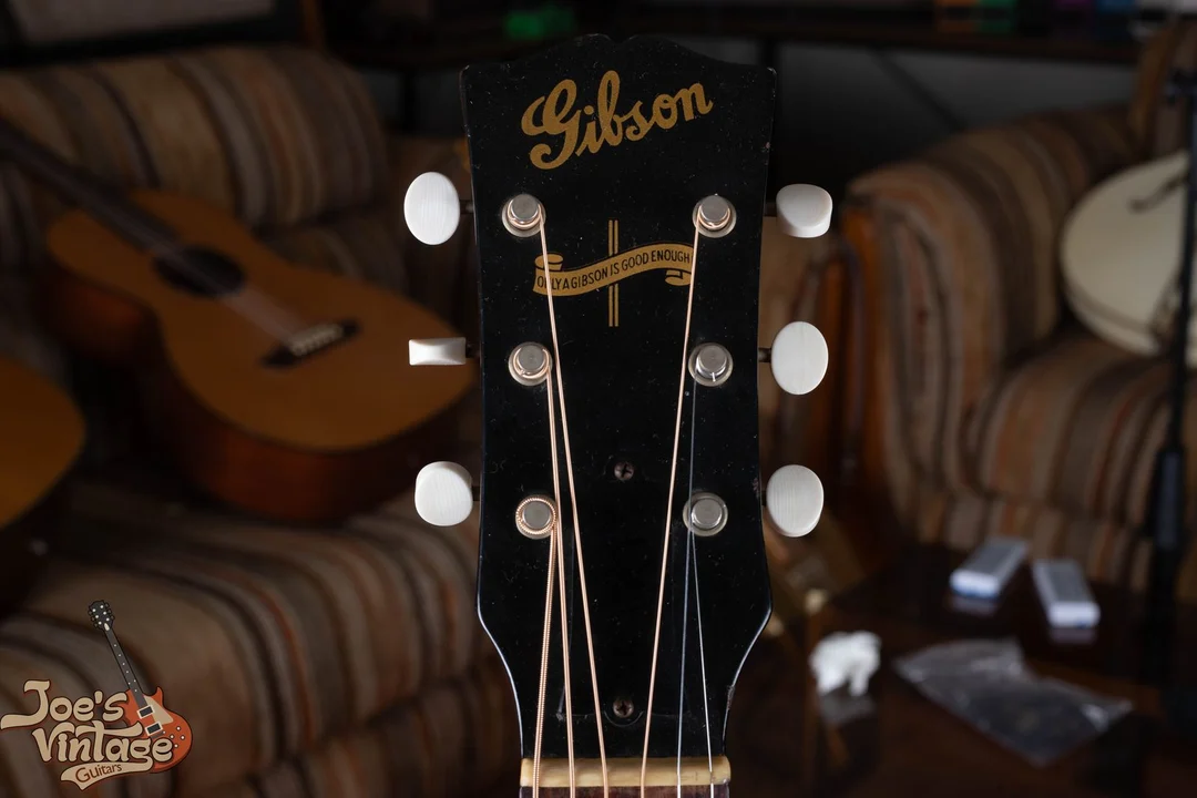 Wartime Gibson headstock with gold script and Only a Gibson Is Good Enough banner