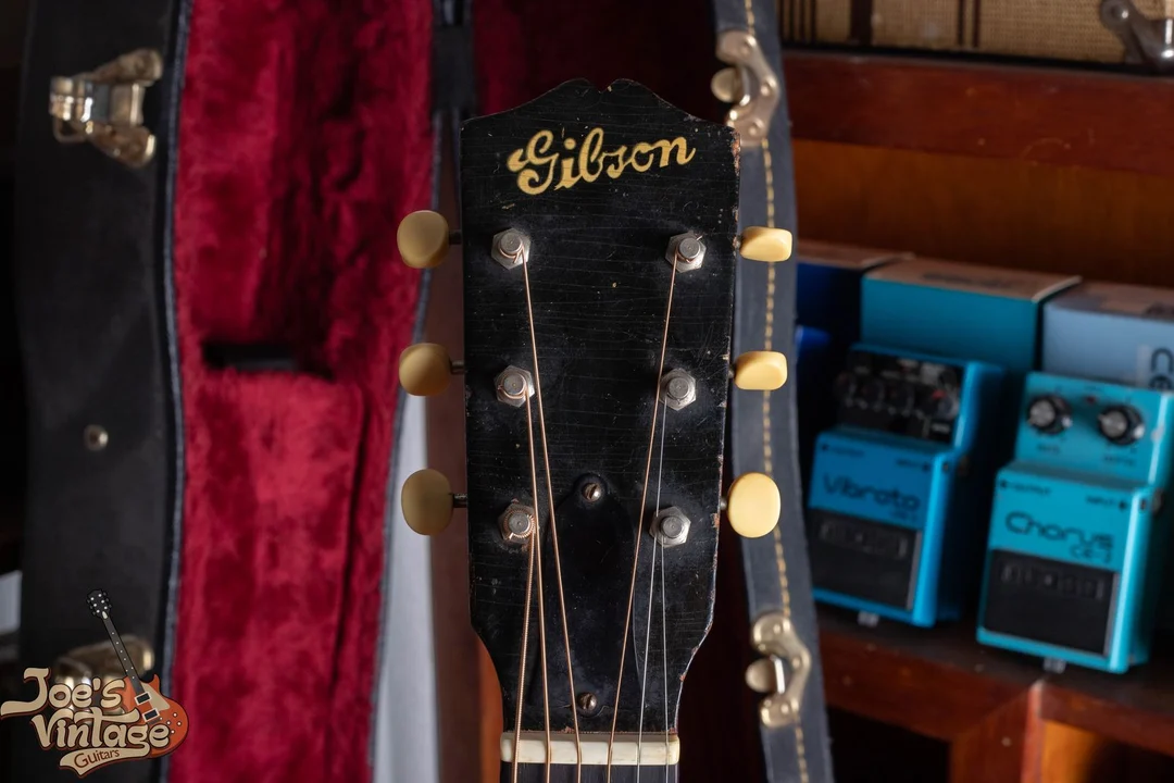 Prewar Gibson headstock with a thick gold Gibson script logo