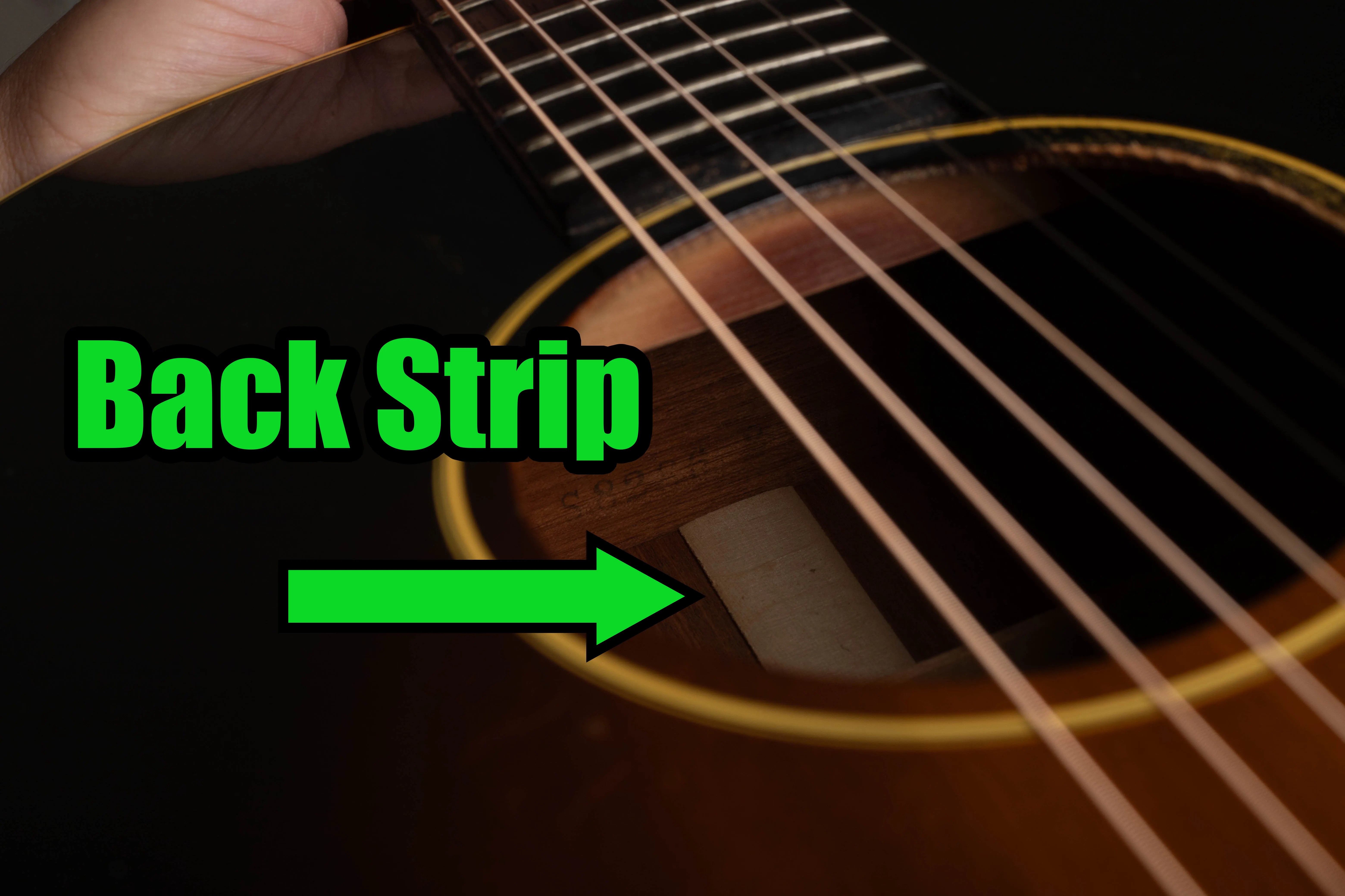 LG-2 soundhole view with a green arrow marking the interior back strip