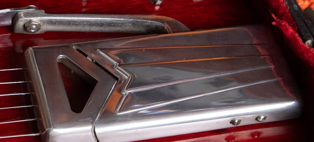 Close-up of the long side-pull vibrato and folding arm on an early SG Standard