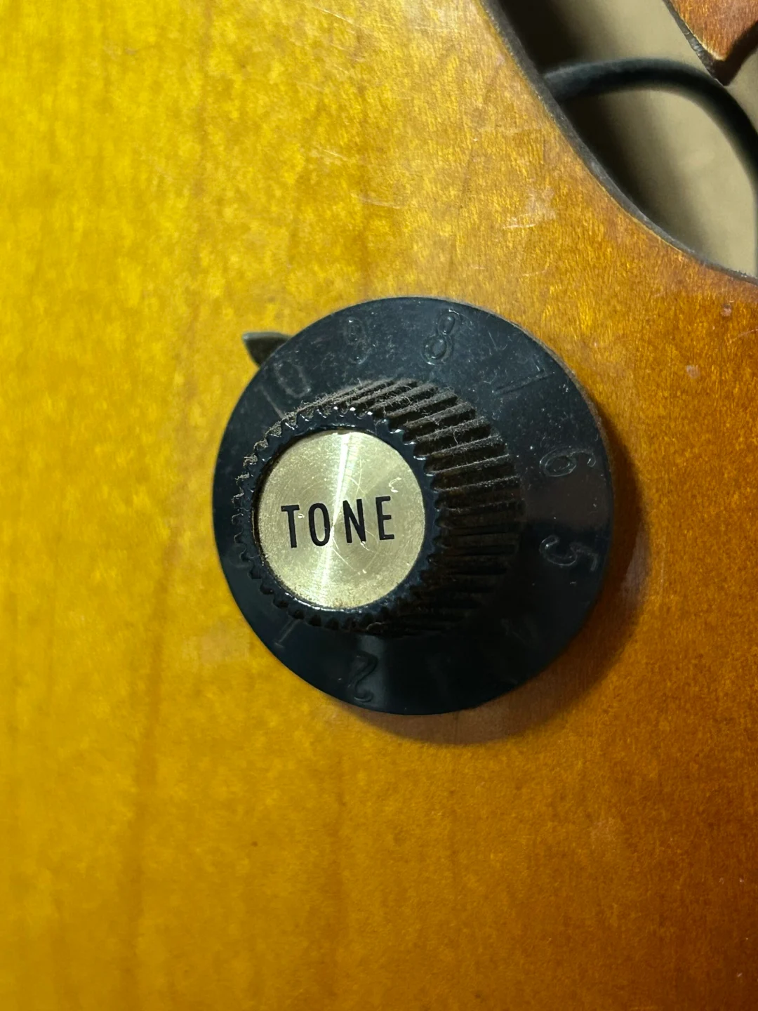 Black Gibson witch-hat tone knob with a tall ribbed center and wide skirt