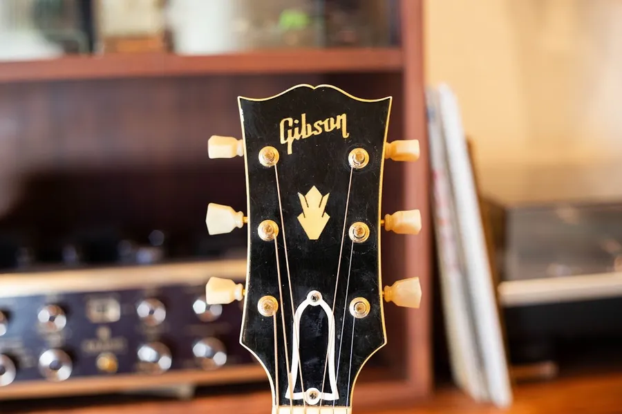 Bound Gibson J-200 headstock with crown inlay and gold-colored tuners