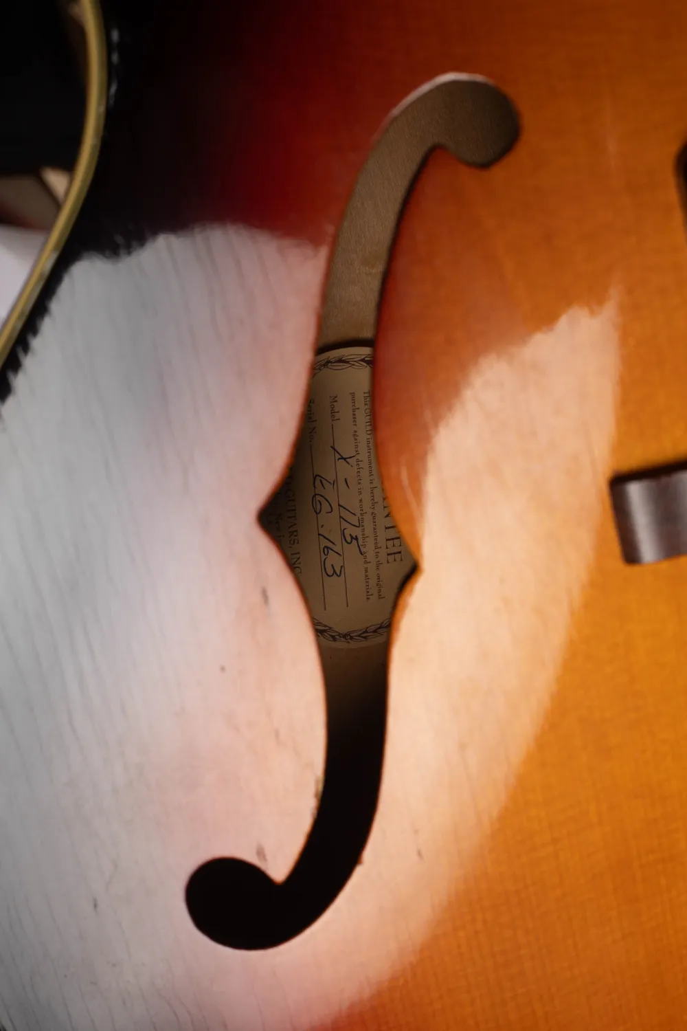 Paper label through the f-hole of a later Guild X175