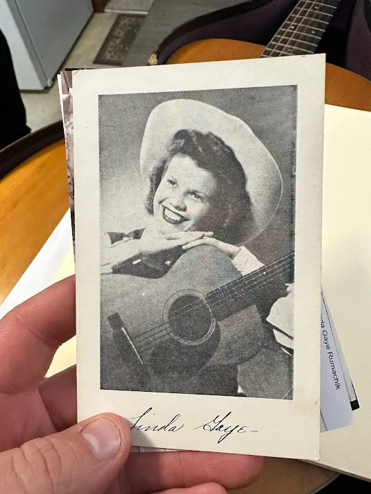 Historic publicity photograph of Iowa country western musician Linda Gayle holding an acoustic guitar