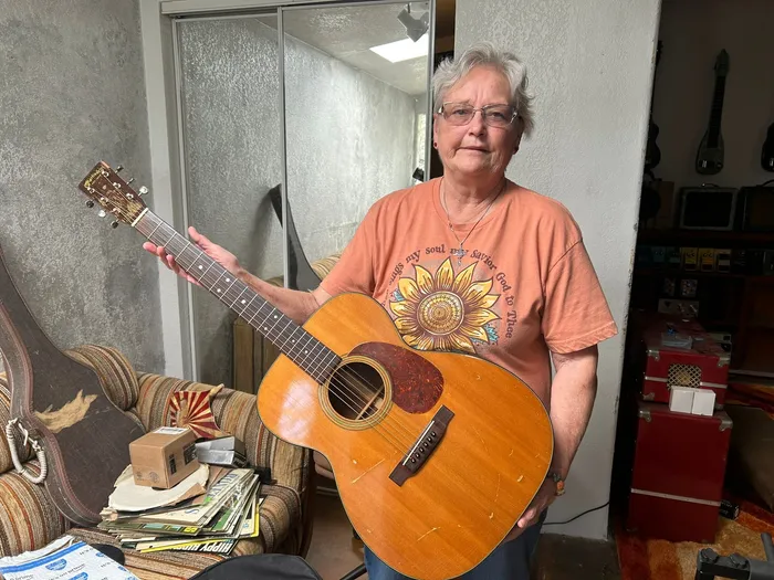 The original owner's daughter holding the family's 1956 Martin 000-21