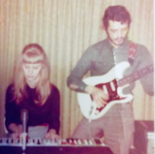 The original owner playing the Stratocaster beside his wife at a keyboard