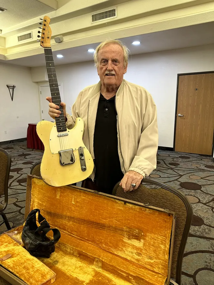 The original owner holding his worn 1960 Fender Telecaster in Fountain Hills, Arizona
