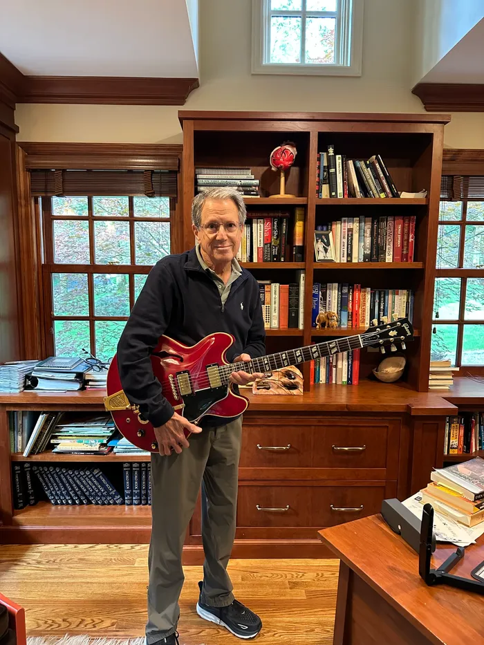 The original owner holding his 1966 Gibson ES-345 at his Connecticut home