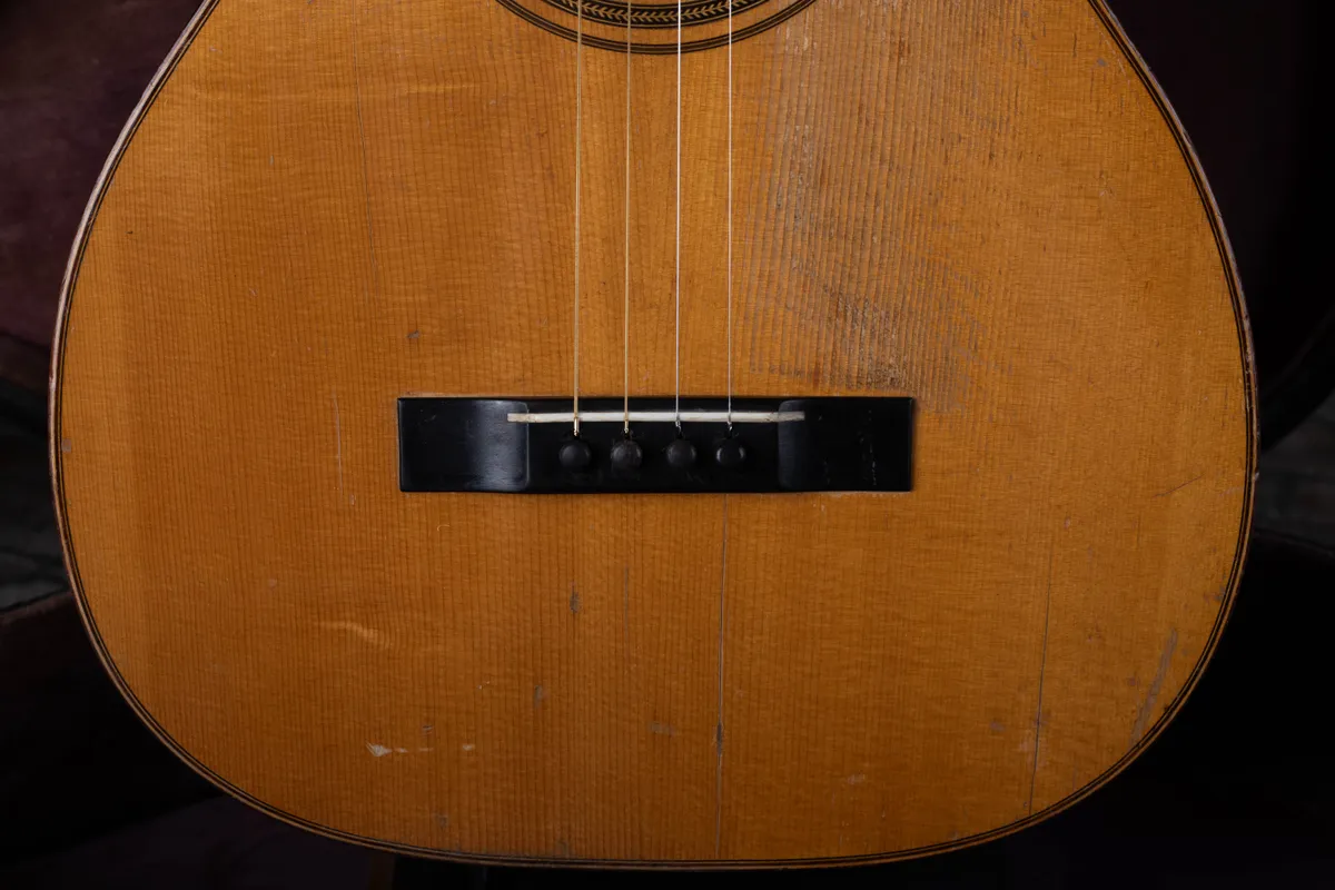Four-pin bridge of a 1927 Martin 5-21 tenor used as a comparison for four-string identification