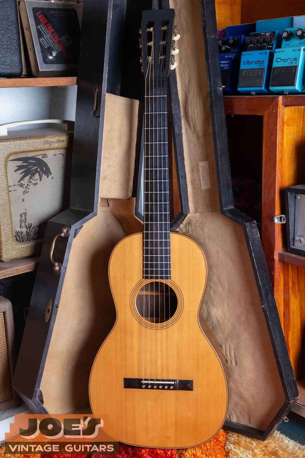 Full front of an 1860s Martin 2½-17 in an open coffin-style case