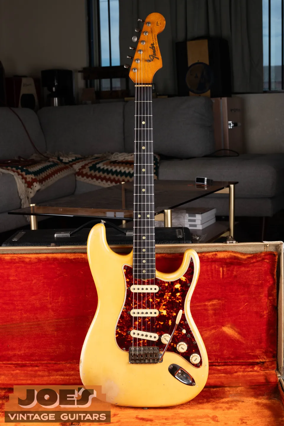 Full view of the 1965 Olympic White Stratocaster and its rare factory tortoise pickguard