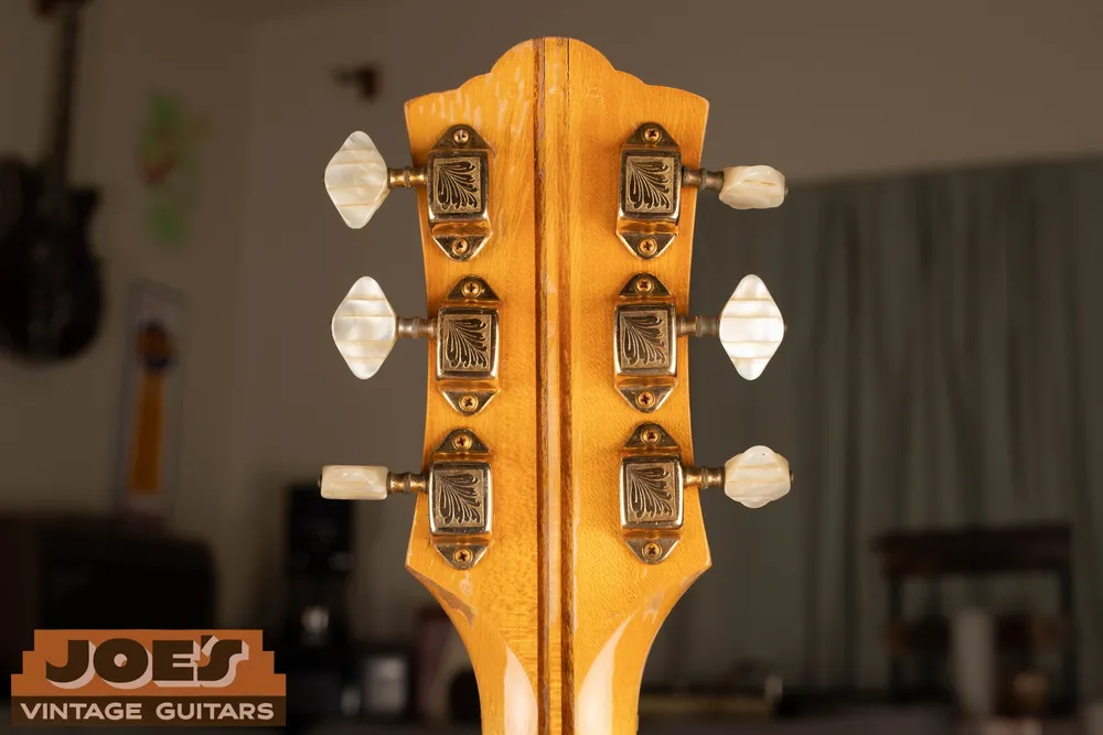 Gold-colored Kolb-pattern tuners on the rear of a Guild X500 headstock