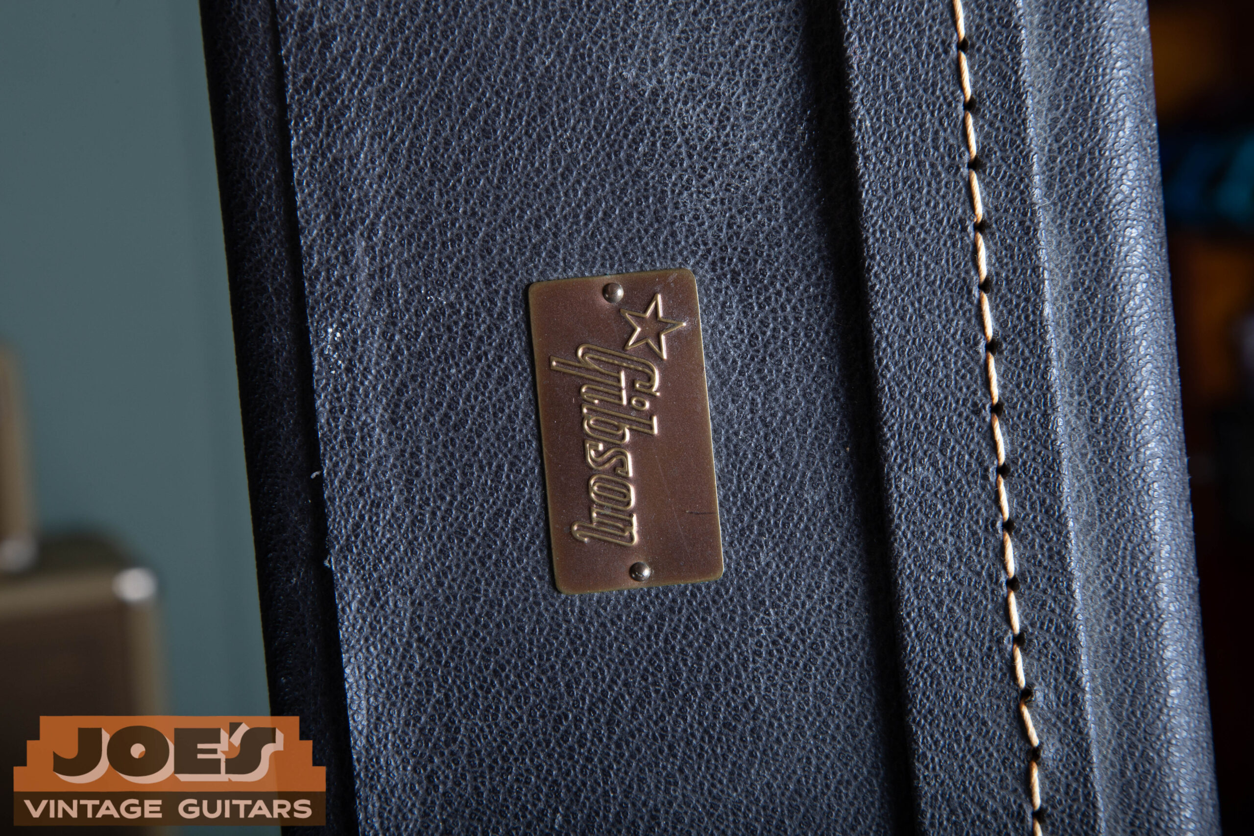 1966 Gibson ES-335 case exterior showing Gibson logo plaque, correct black hardshell case with period Gibson badge confirming mid-1960s case