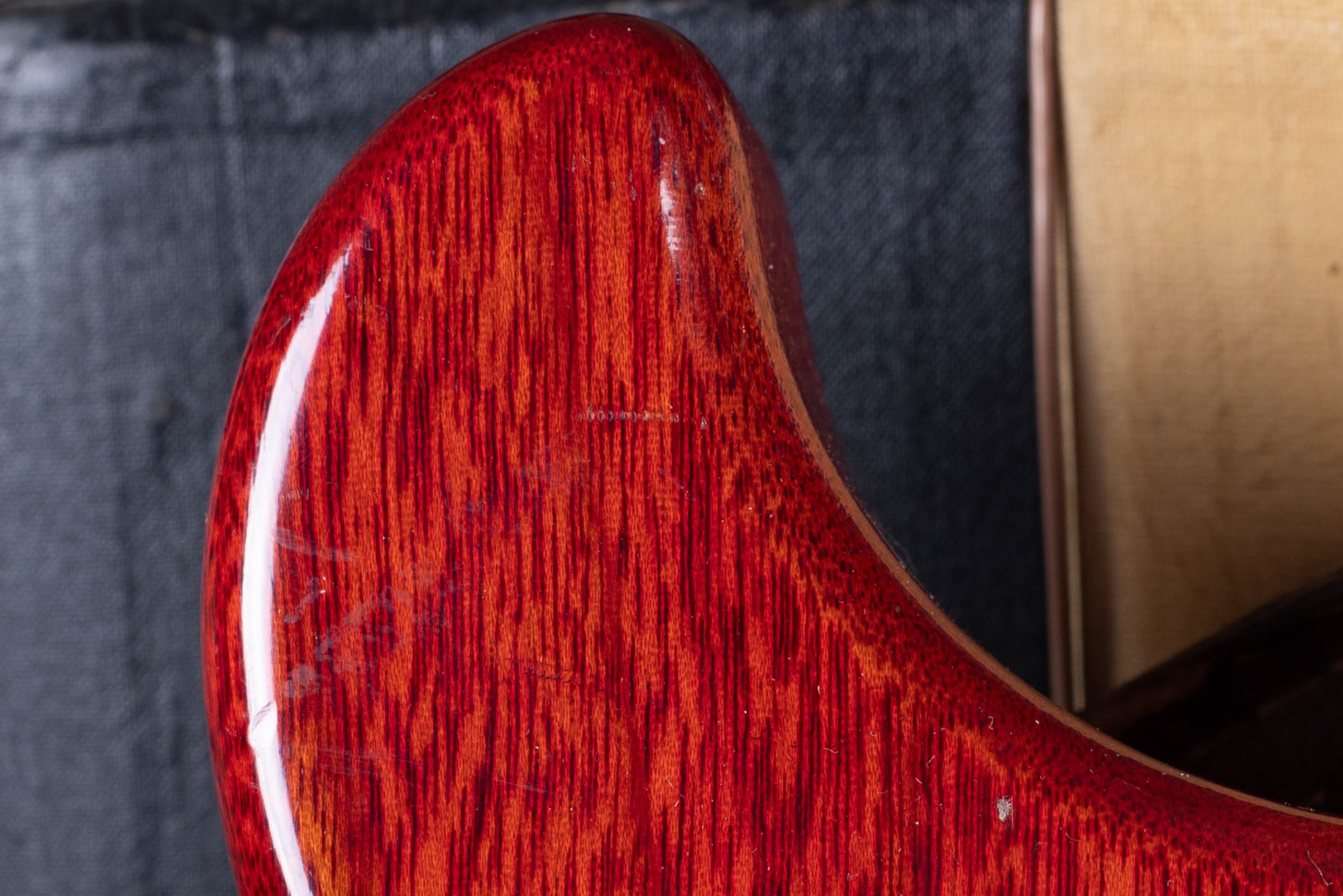 Cherry finish close-up on a vintage Gibson Les Paul, showing the translucent red over mahogany grain characteristic of the period