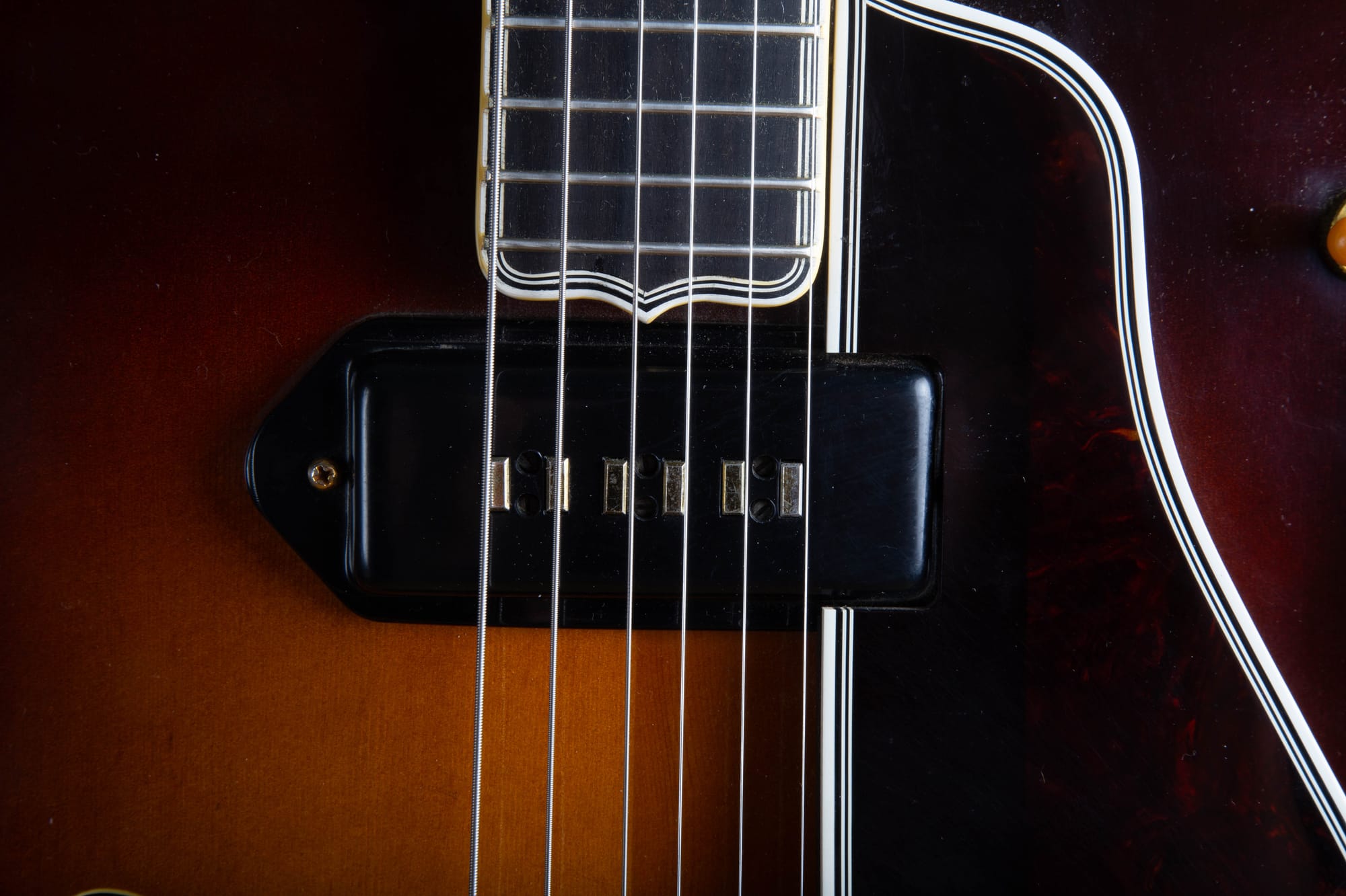 Close-up of a gold Alnico staple pickup on a 1957 Gibson Byrdland, showing the six rectangular staple magnets