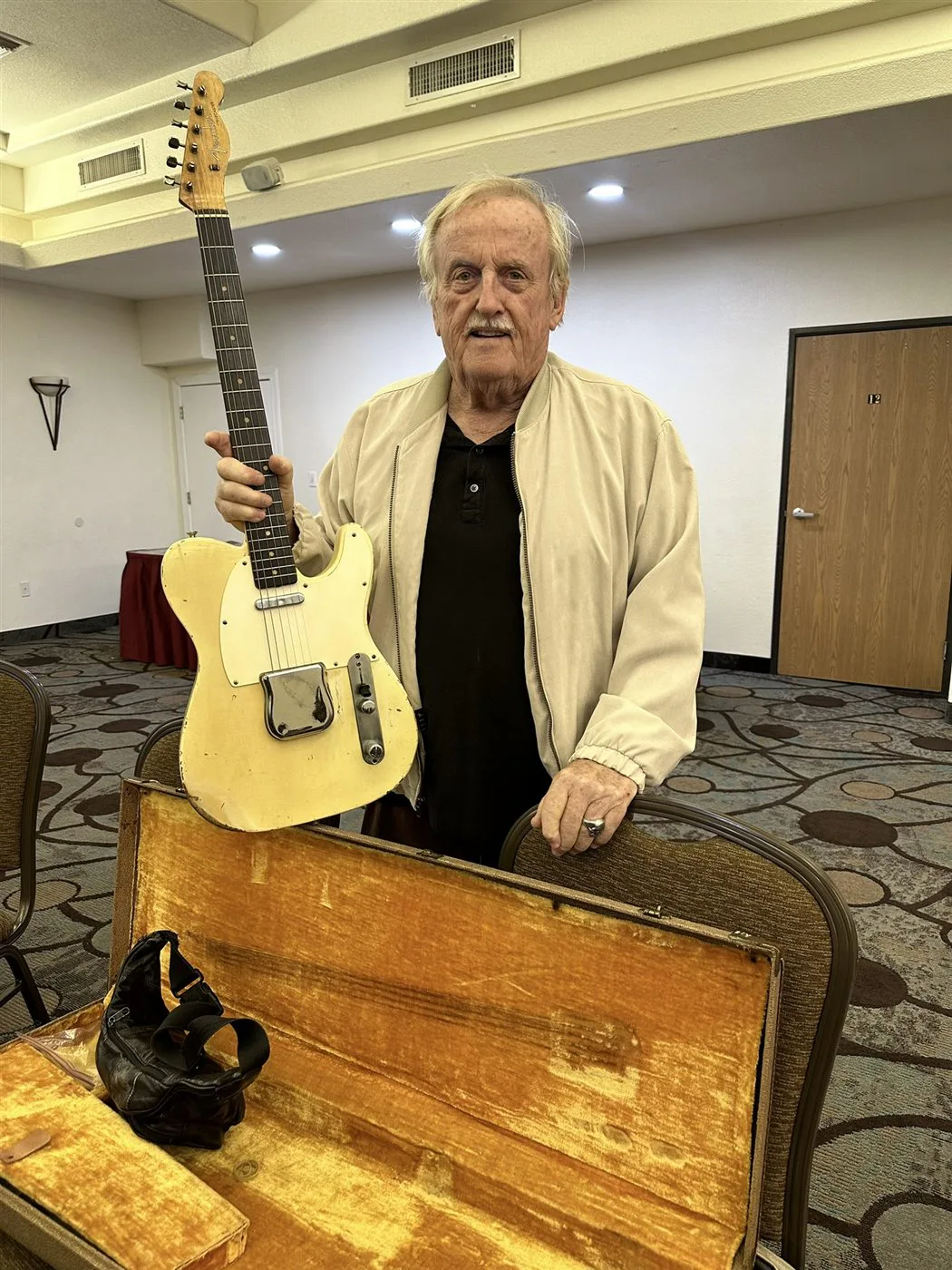 The original owner holding his worn 1960 Fender Telecaster in Fountain Hills, Arizona