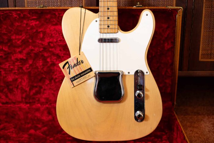 The front of the Fender Telecaster with bridge cover and hang tag included