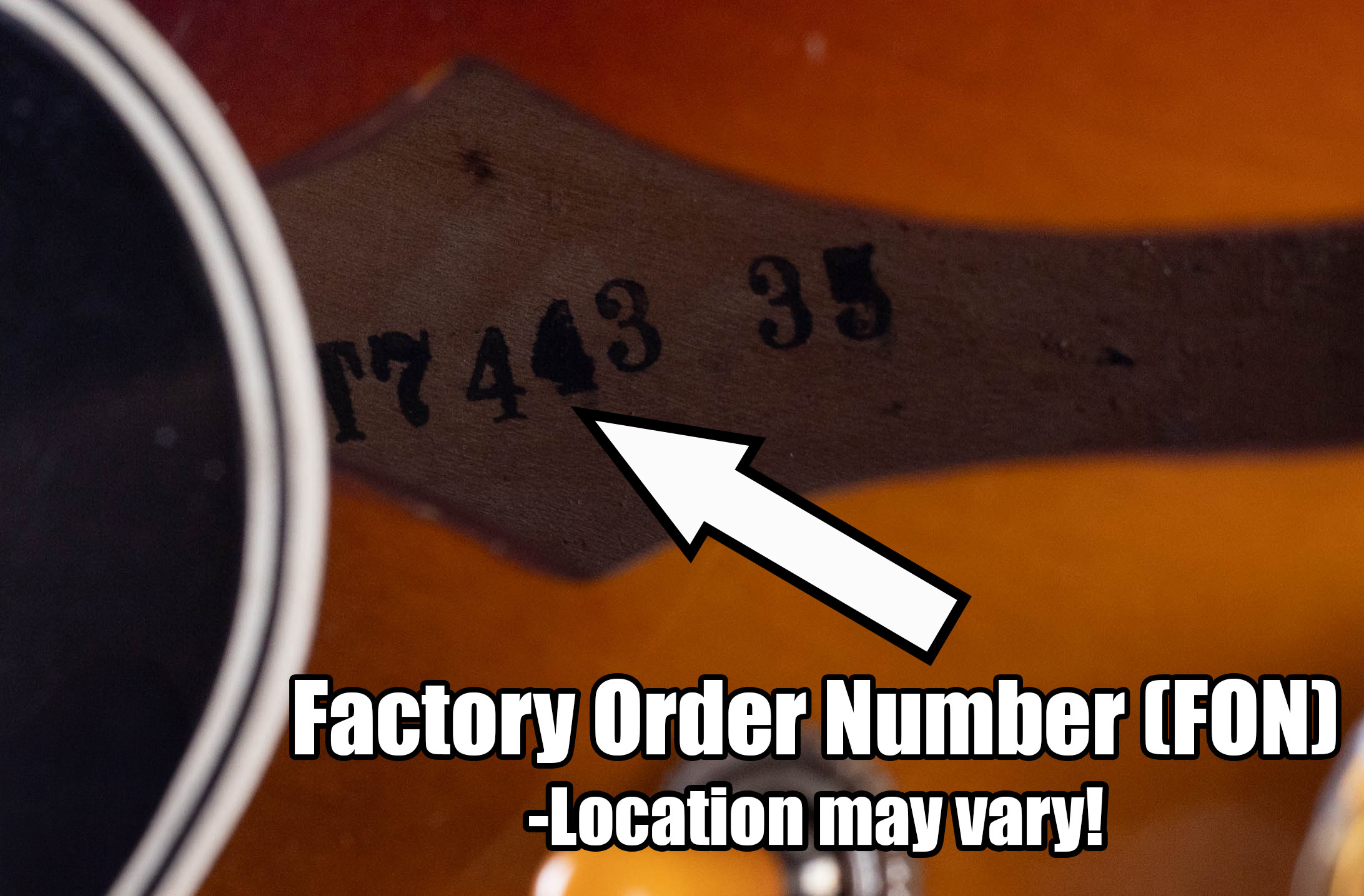 Gibson Factory Order Number ink stamped on the bare interior wood of a vintage Gibson guitar, showing the batch number used to date the instrument