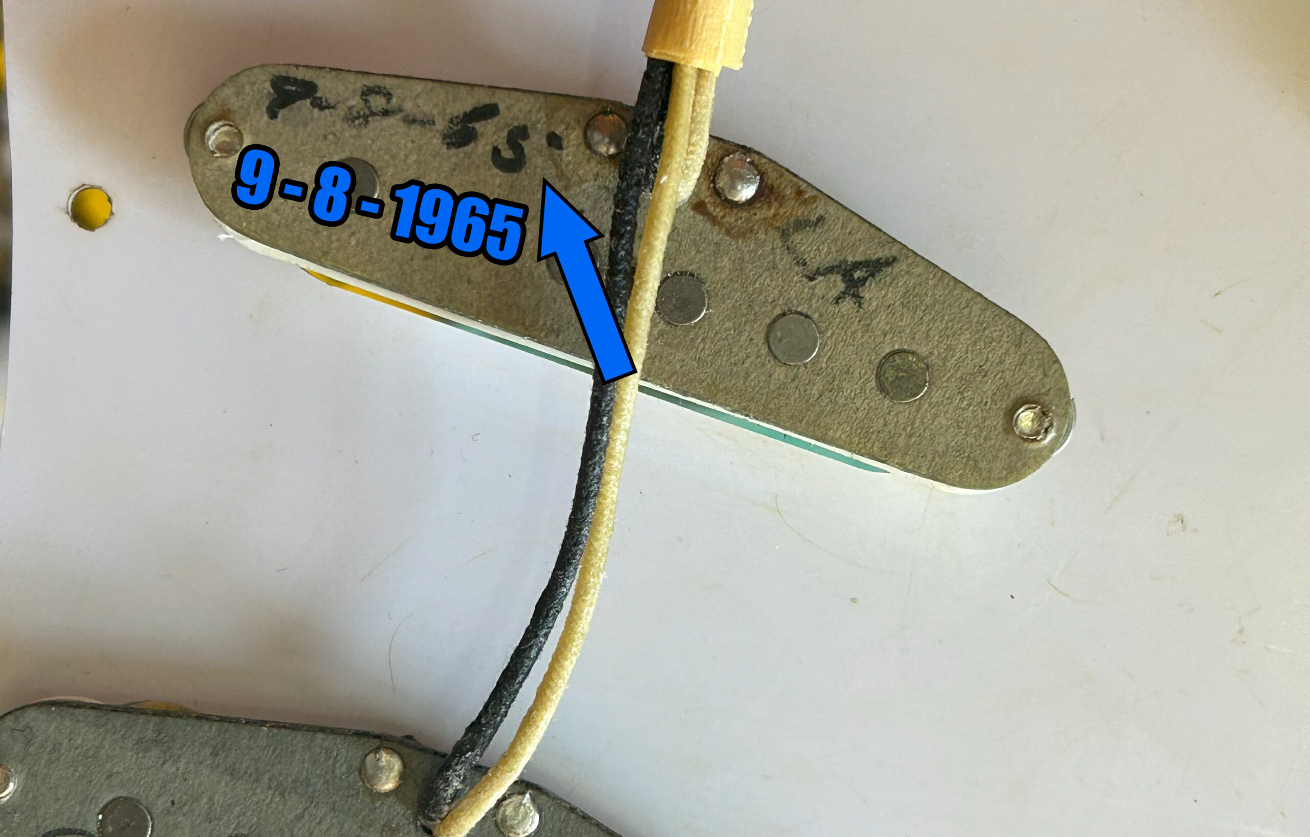Close up of vintage Fender pickup showing ink date code