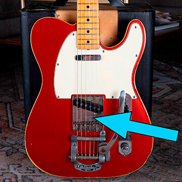 The bridge plate of a Fender Telecaster guitar
