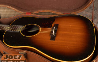 A 1950s Gibson J-45 in its original case. Sunburst finish