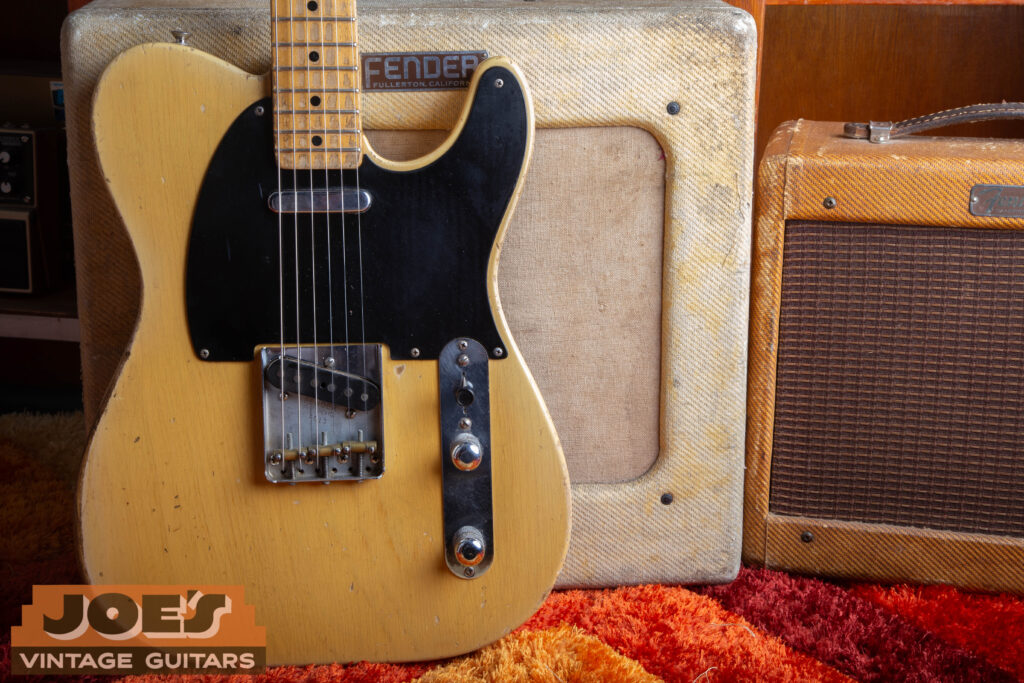 1952 Fender Telecaster body in Butterscotch Blonde finish featuring black phenolic pickguard and brass bridge saddles.