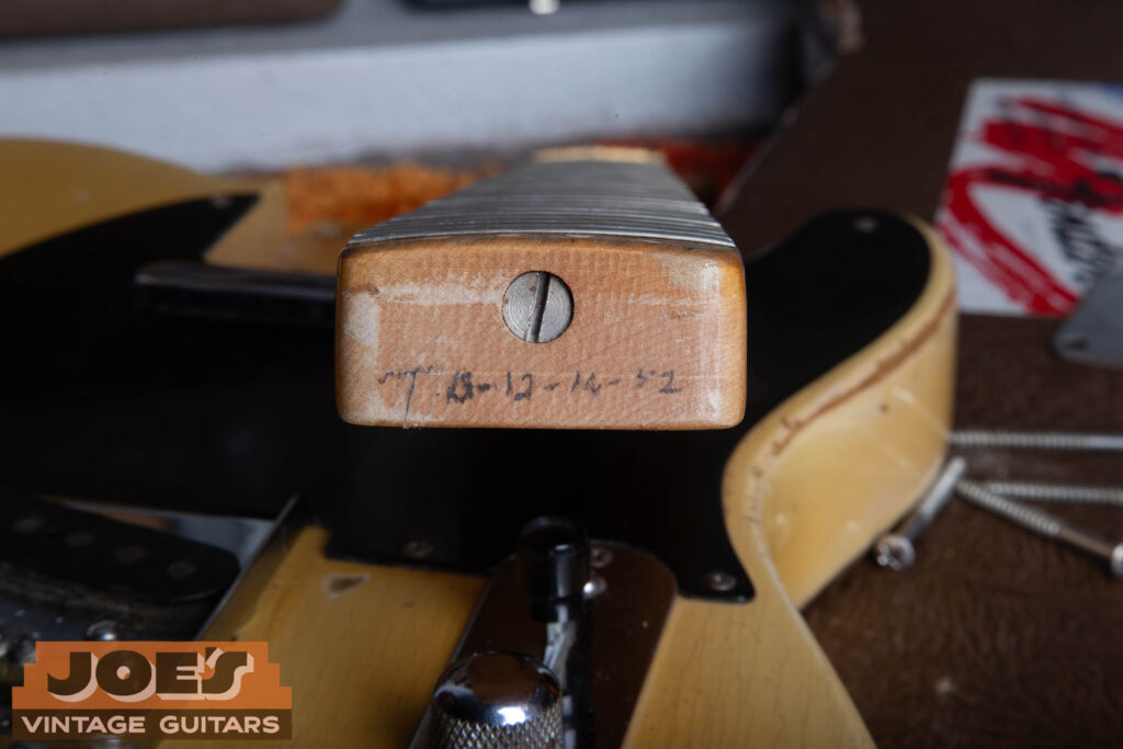 Close-up of a 1952 Fender Telecaster neck heel featuring a period-correct flat-head (slot-head) truss rod adjustment screw.
