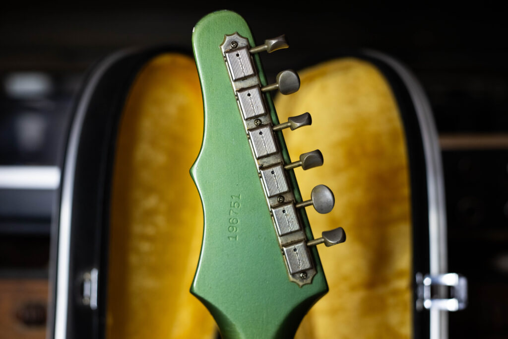 Rear view of a 1964 Epiphone Crestwood asymmetrical "Batwing" headstock, showing the six-in-line Kluson tuners and the custom color finish.