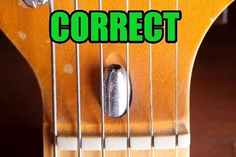 Authentic USA Fender guitar headstock showing original dark walnut wood truss rod plug