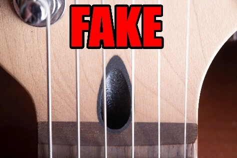 Fake Fender guitar headstock with black plastic truss rod insert instead of walnut plug