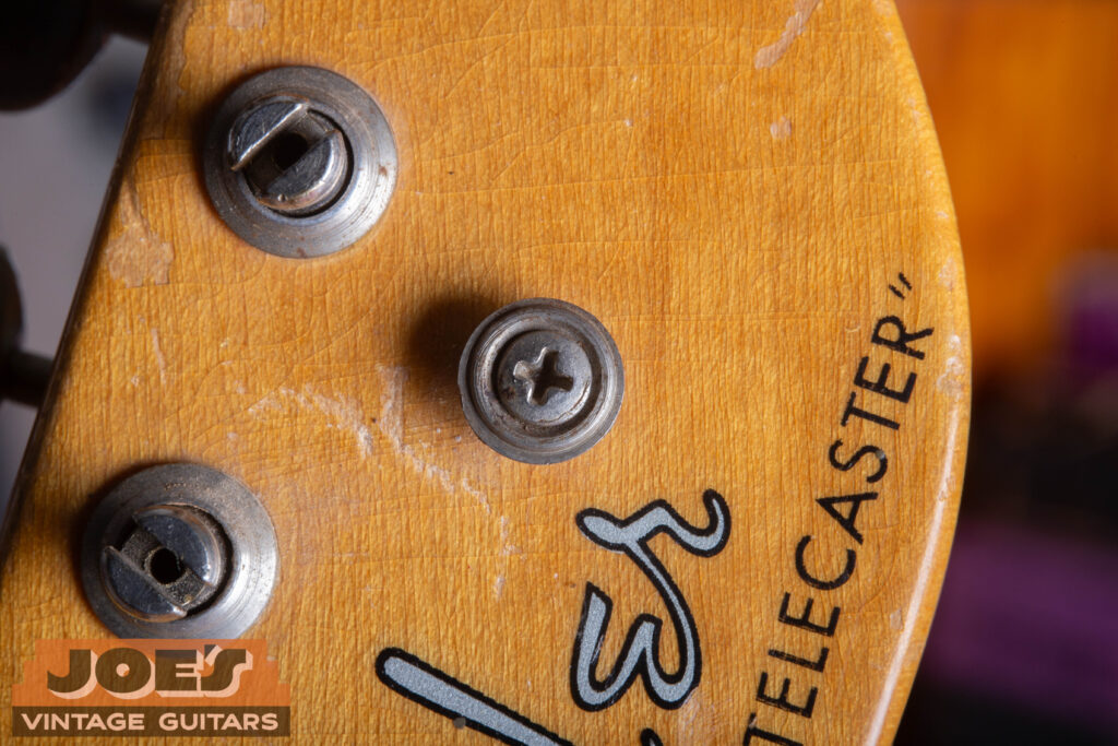 Close-up of a 1952 Fender Telecaster headstock featuring the original circular button-style string tree.