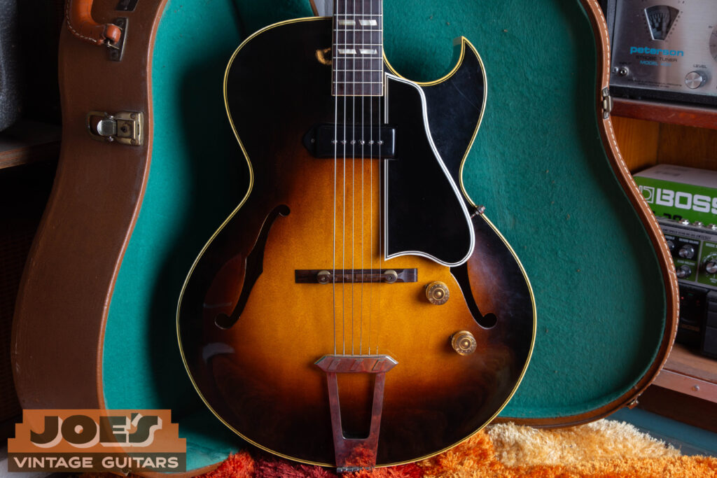 A vintage Gibson ES-175 hollow-body electric guitar in a classic Sunburst finish, showcasing the iconic Florentine cutaway and double-parallelogram fingerboard inlays.