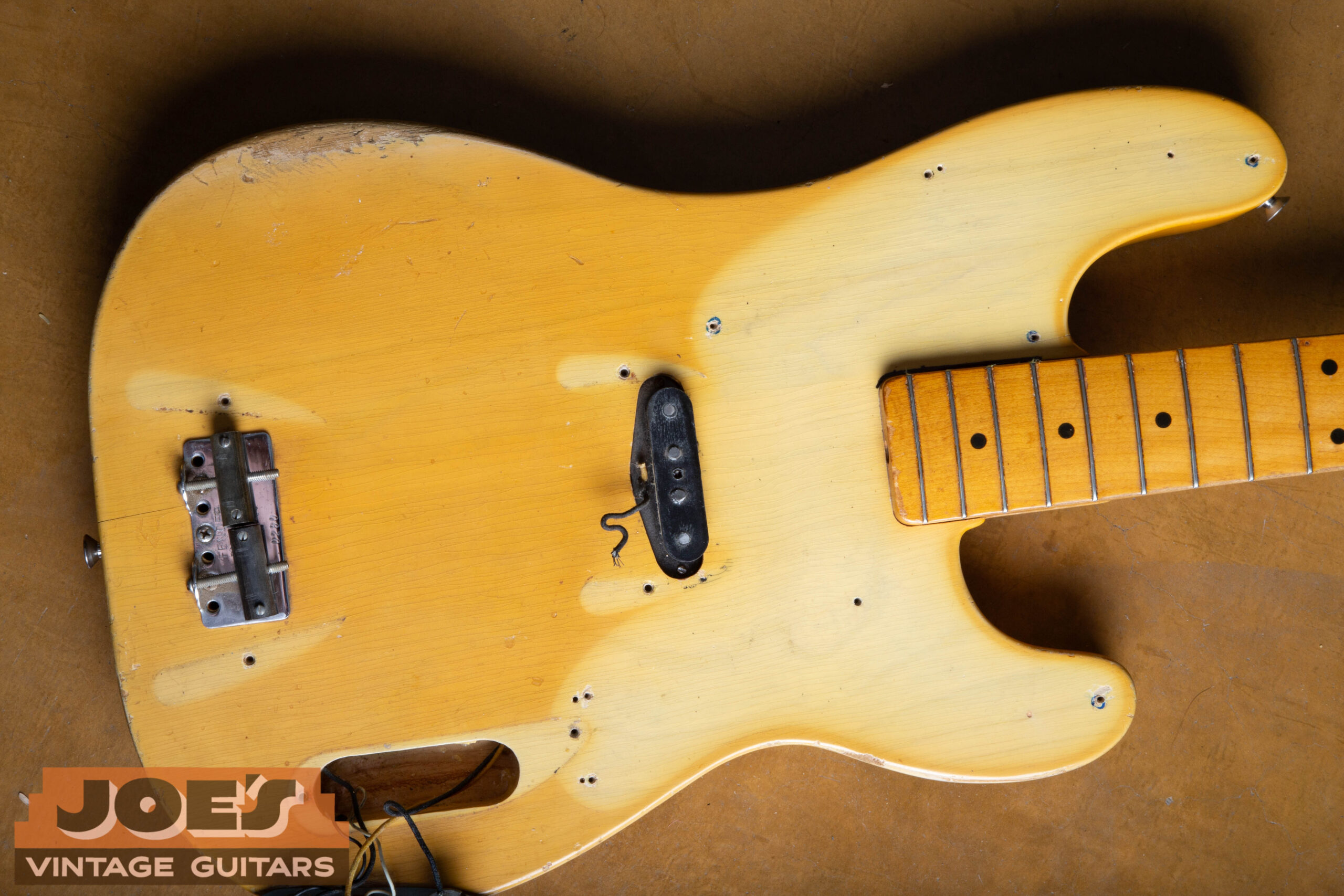 Tan lines visible on 1952 Fender Precision Bass body under pickguard, covers and control plate