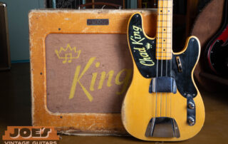 A stunning lifestyle photograph featuring an investment-grade 1952 Fender Precision Bass paired with a matching "TV Front" 1952 Fender Bassman amplifier. The bass features the original owner's name neatly hand-painted on the black phenolic pickguard, mirrored by the same personalized name on the amp's original linen grill cloth—a rare, documented piece of provenance linking these two instruments as a lifetime pair.