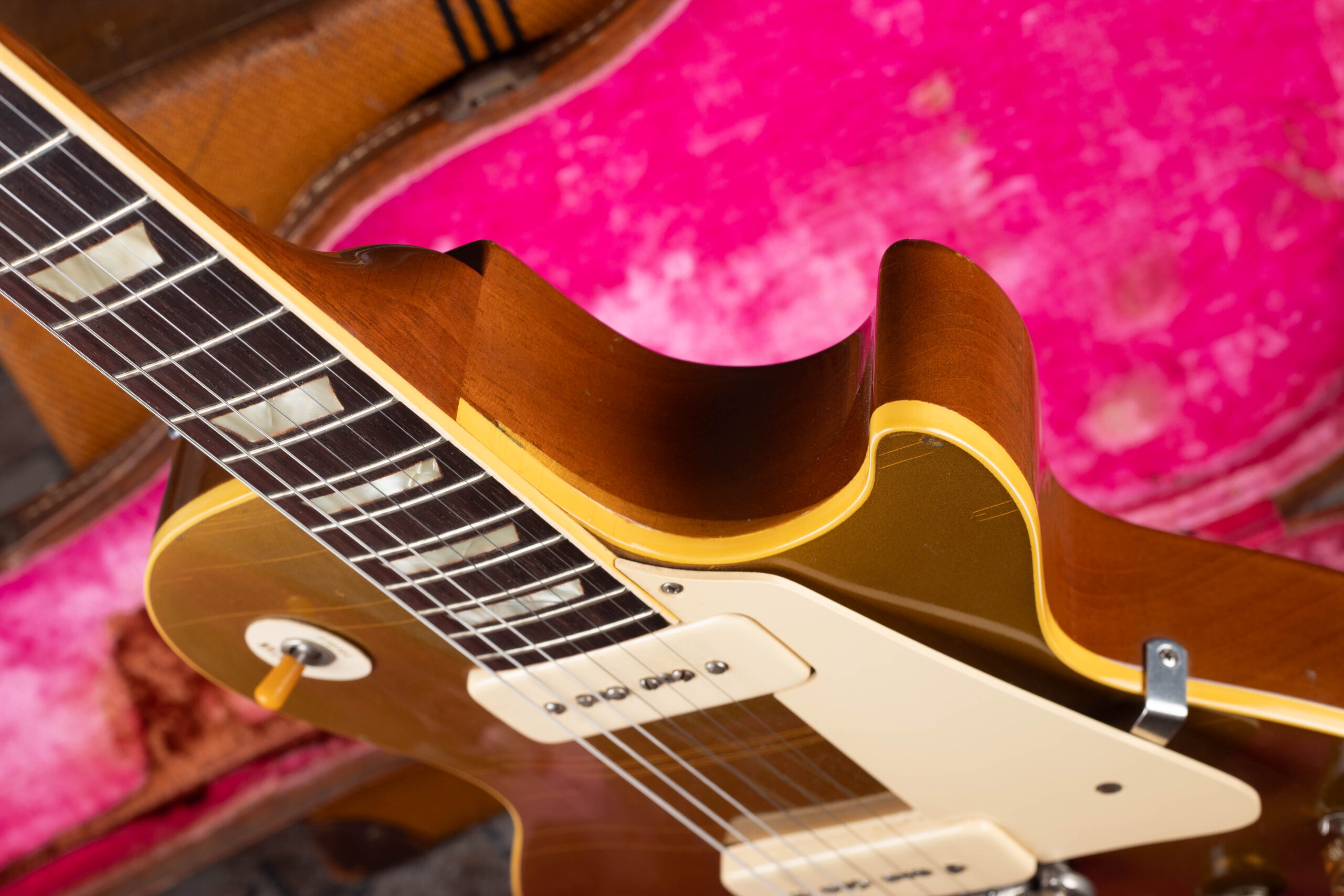 1954 Gibson Les Paul Goldtop maple top visible at cutaway edge behind cream binding — authentication detail showing carved maple cap beneath gold finish