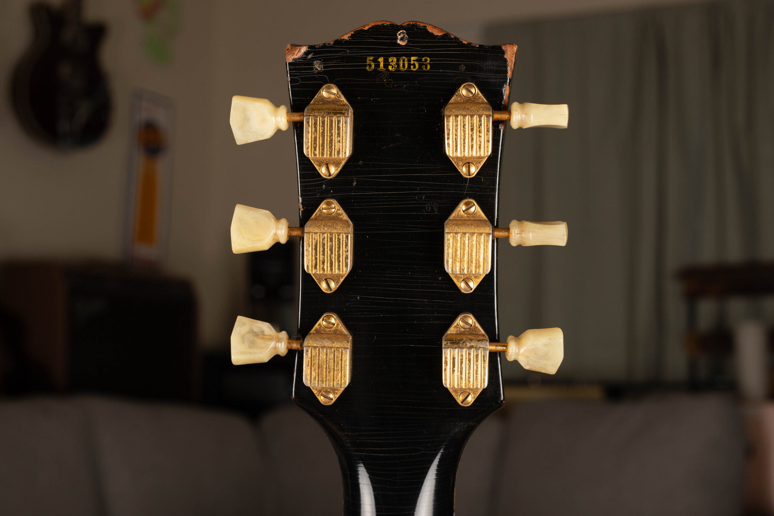 Ink-stamped serial number on the back of the headstock of a 1955 Gibson Les Paul Custom — the method Gibson used to serialize solid body electric guitars from 1952 through 1960
