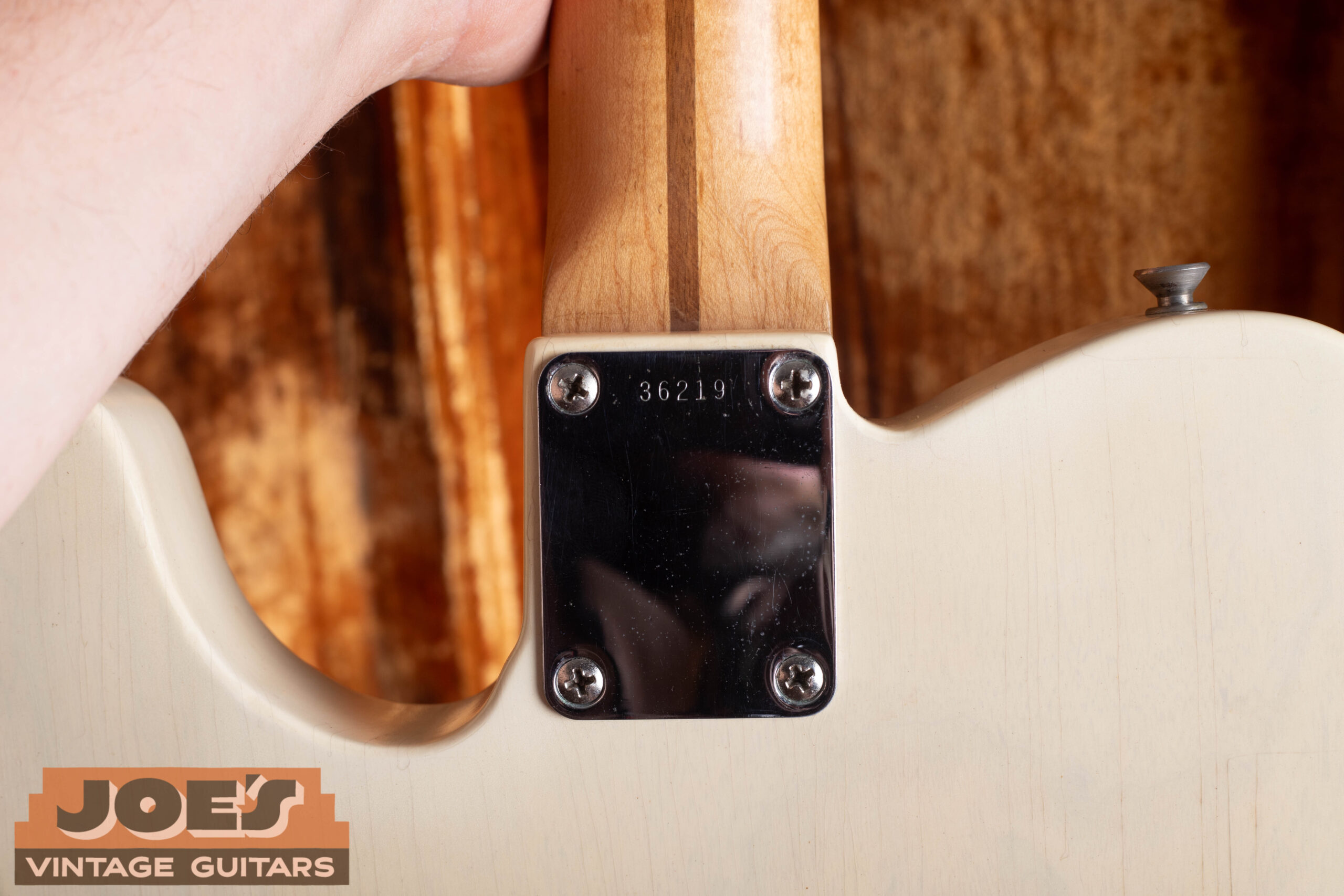 1959 Fender Telecaster neck plate showing 5-digit serial number in 30000-40000 range, four Phillips head screws, and electrode mark from chrome plating